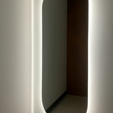 Illuminated mirror in a modern hallway