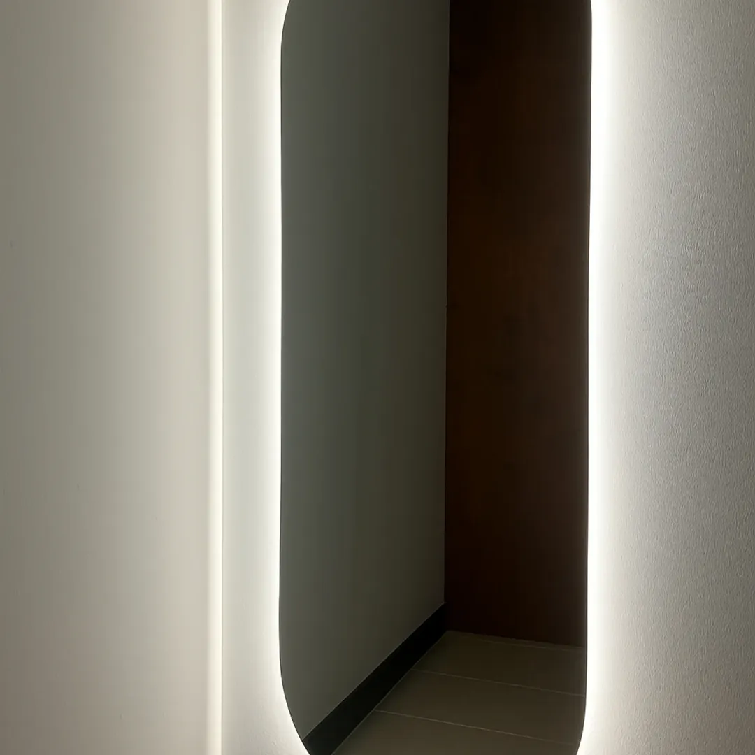 Illuminated mirror in a modern hallway
